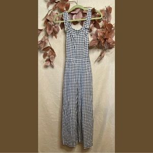 Vonda black and white plaid jumpsuit with wood buttons and button accents.